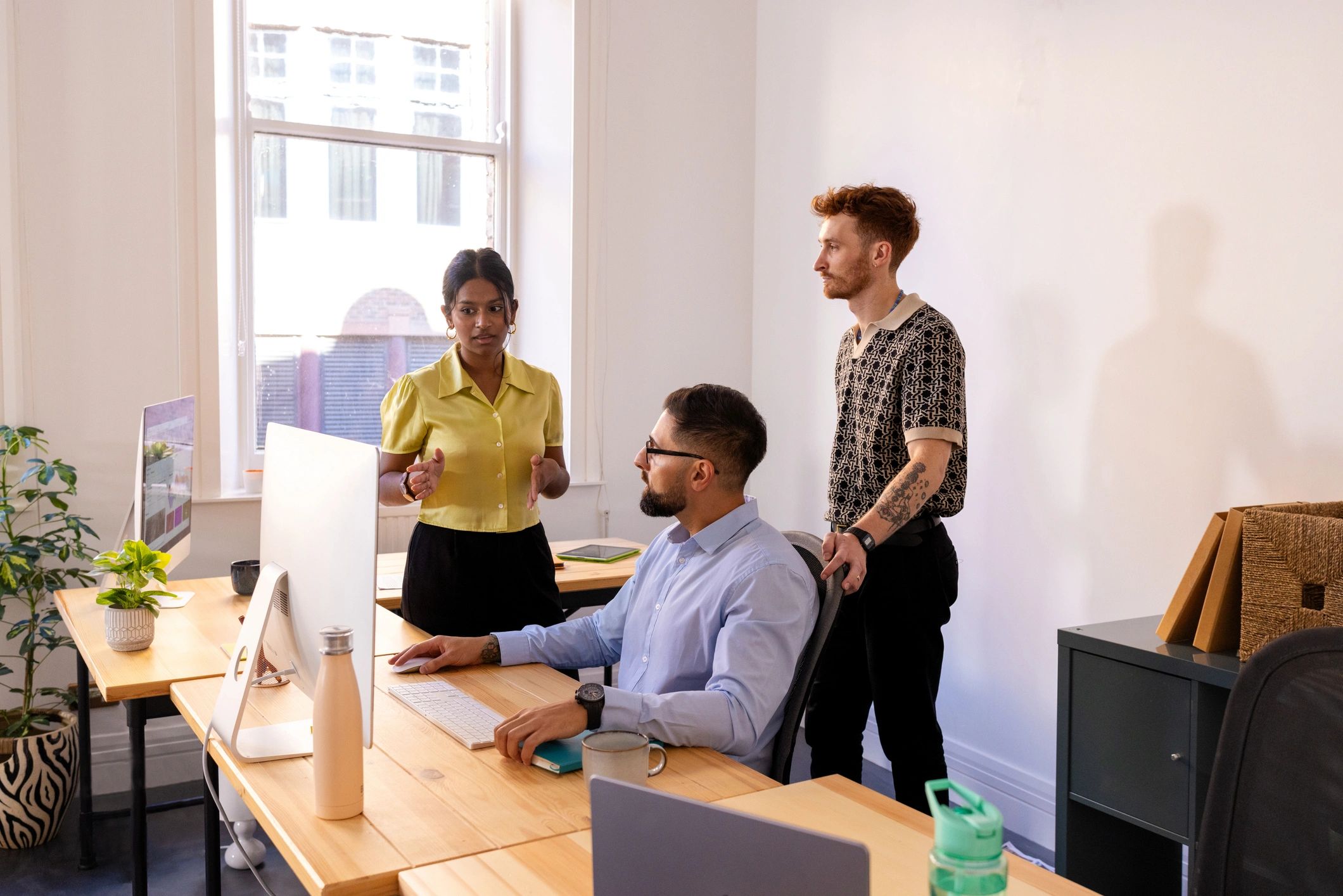 Manager speaking with colleagues in a modern office