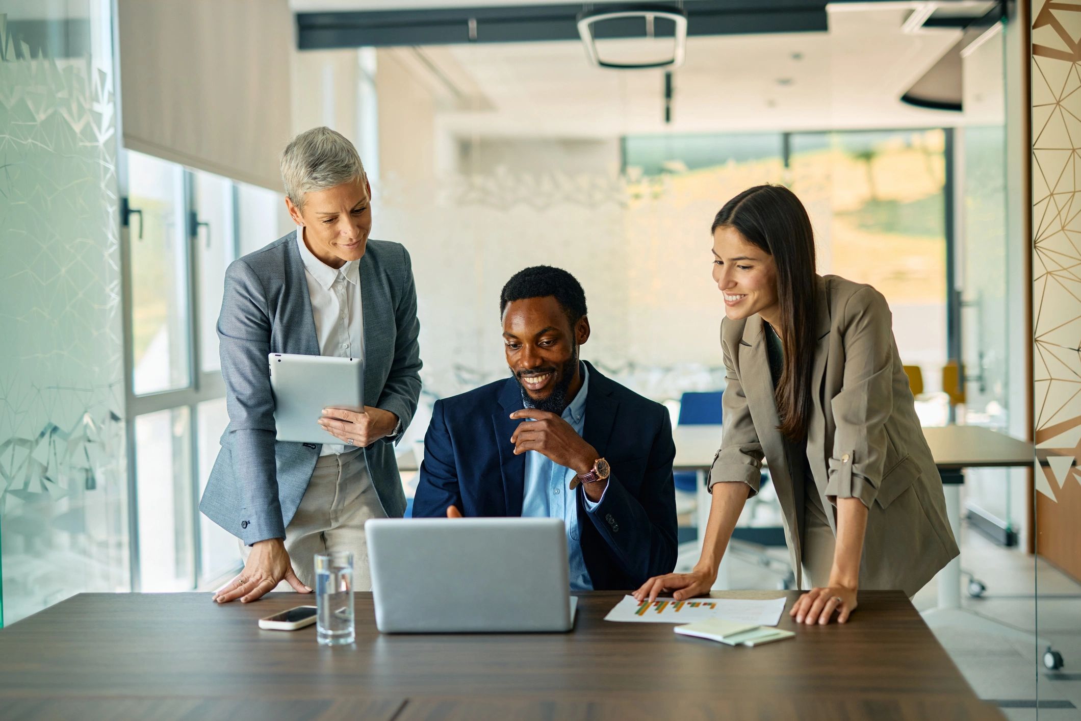 Professionals collaborating with a laptop in an office